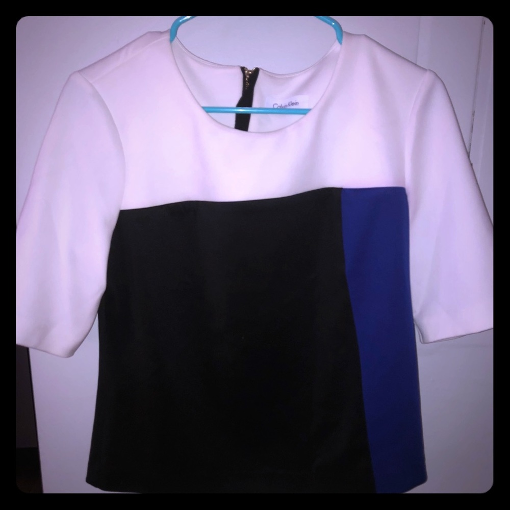 A white,black and dark blue shirt by Calvin Klein.